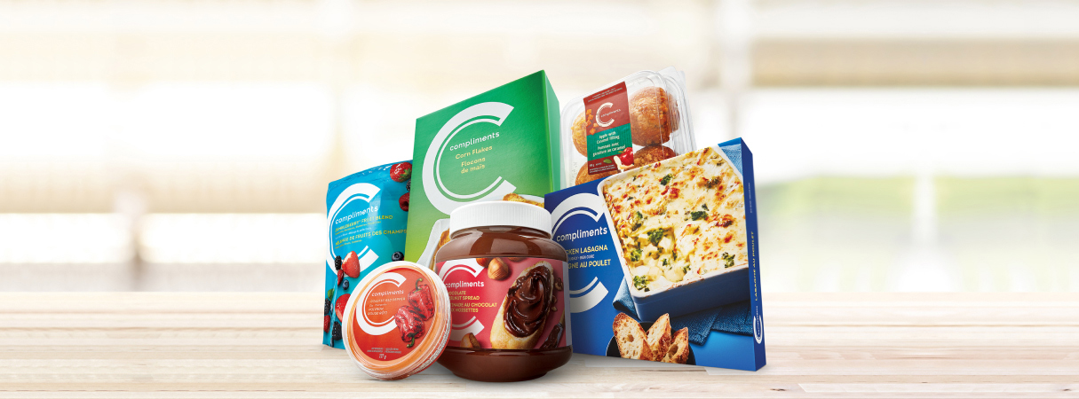 An image of a man carrying sobeys bag filled with fruits and vegetables in a trolley.
